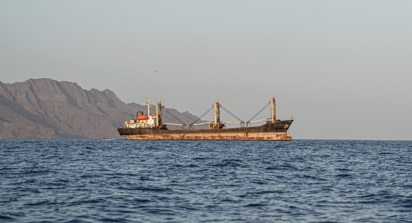 large boat sitting off a coastline