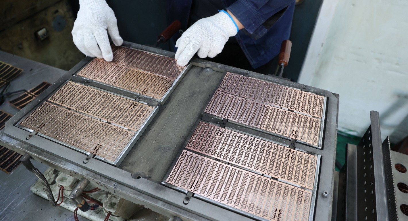 hands holding semiconductors in production