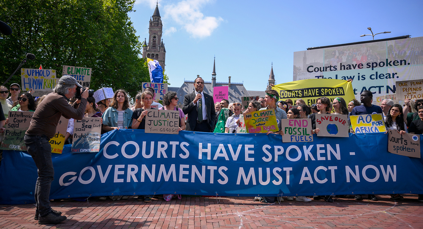 Vanuatu's Climate Change Minister Ralph Regenvanu (C) delivers a speech as he attends a demonstration ahead of the International Court of Justice (ICJ) session tasked with issuing the first Advisory Opinion (AO) on States' legal obligations to address climate change, in The Hague on July 23, 2025. (