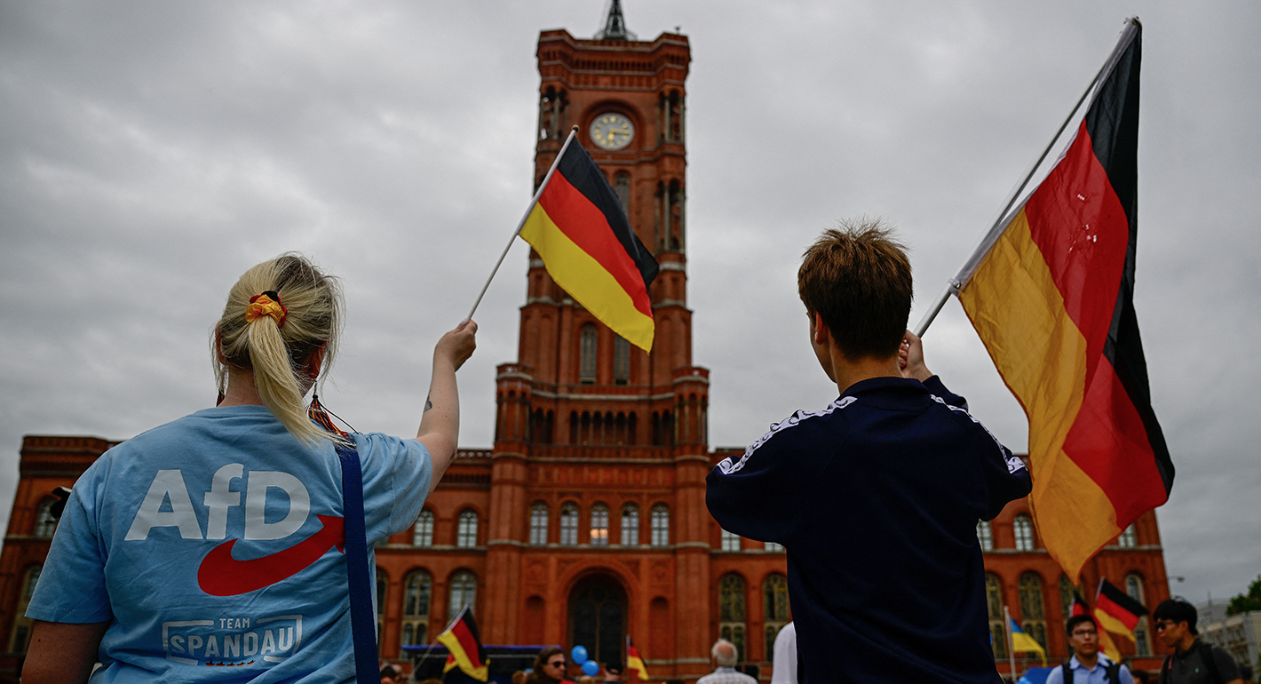 Supporters of the far-right Alternative for Germany (AfD) party wave German flags at a campaign rally in front of the Berlin City Hall on June 29, 2026. 