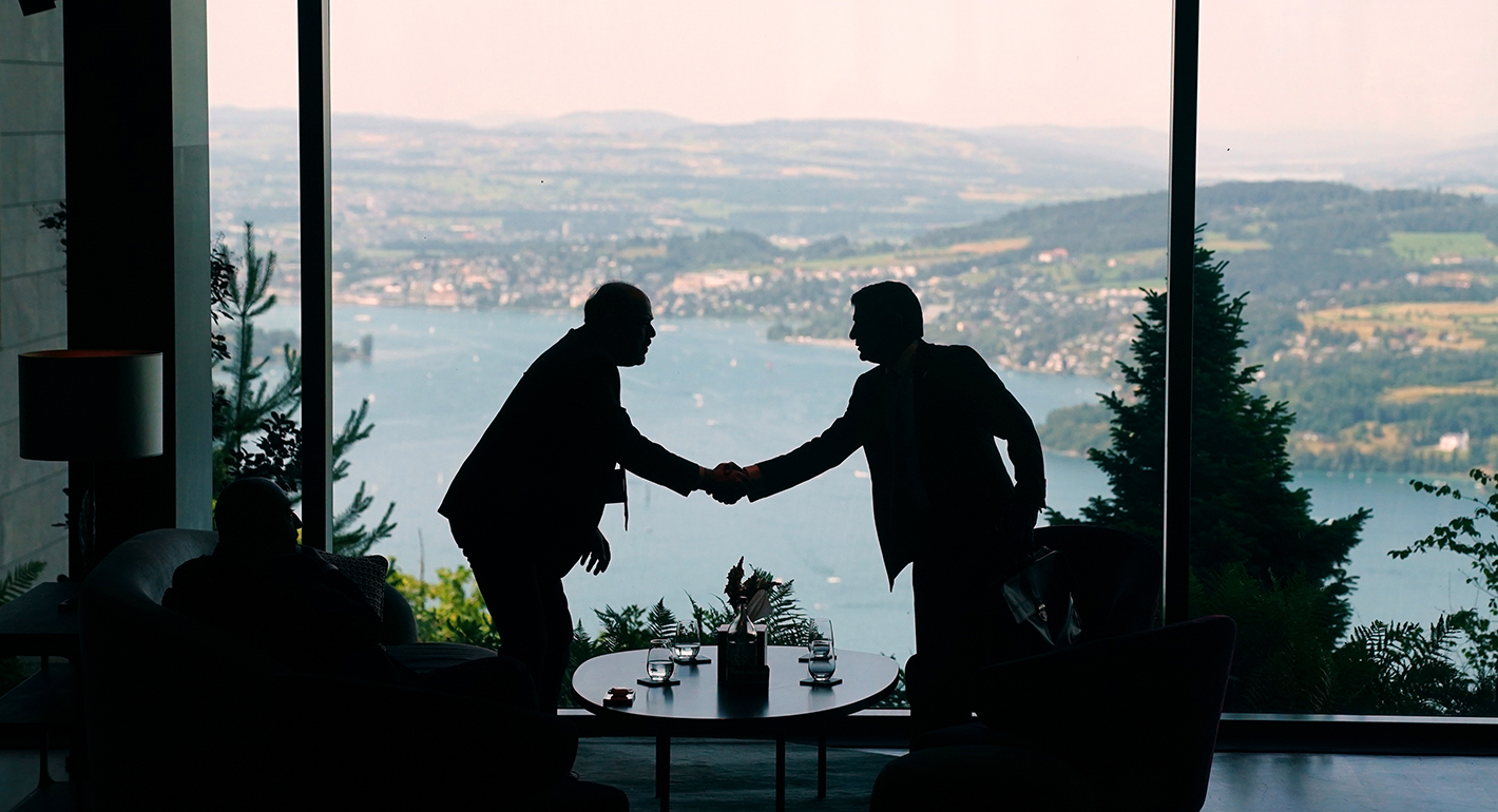  Delegation staff members meet in the lobby during a quadrilateral meeting between the U.S., Iran, Pakistan, and Qatar at the Lake Lucerne Summit, aimed at advancing a deal to end the Middle East conflict at the Buergenstock Resort, Lake Lucerne on June 21, 2026 near Stansstad, Switzerland. 
