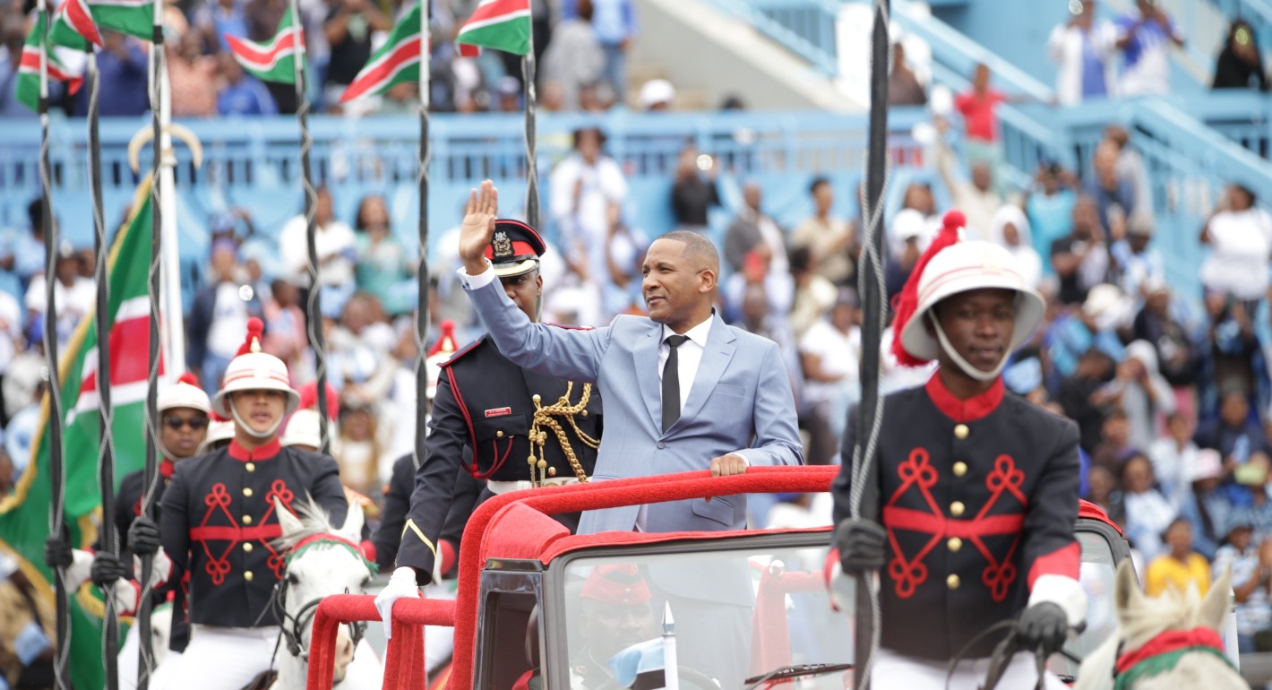 Photo of Duma Boko in a gray suit waving at a crowd.