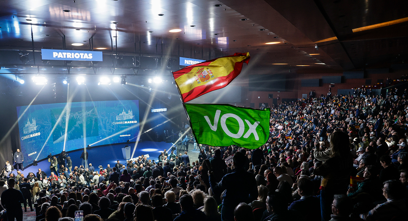 Supporters wave VOX and Spanish flags at the start of Patriots for Europe rally at Marriott Auditorium Hotel on February 08, 2025 in Madrid, Spain