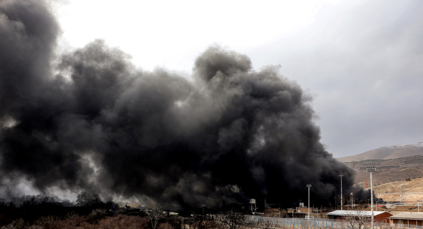 Photo of black smoke rising from an Iranian oil facility after an airstrike.