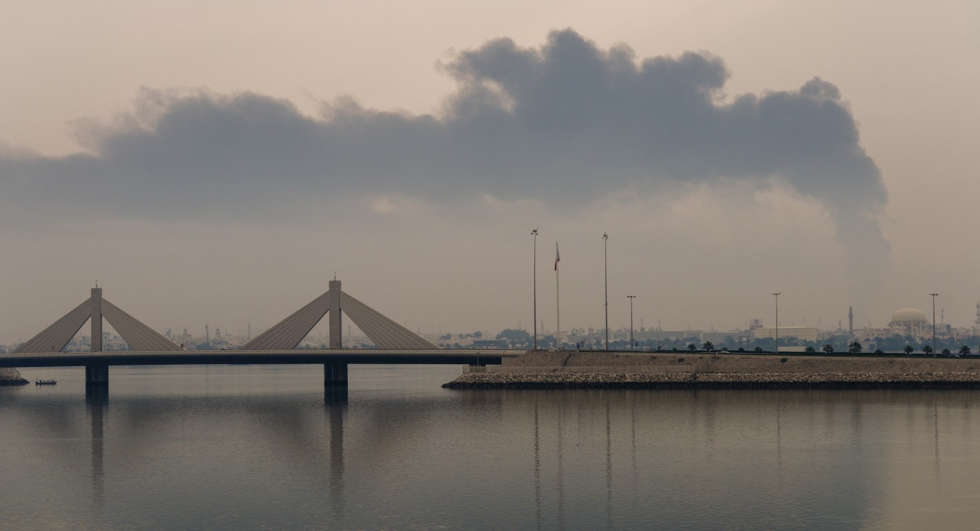 Smoke rising over a  bridge