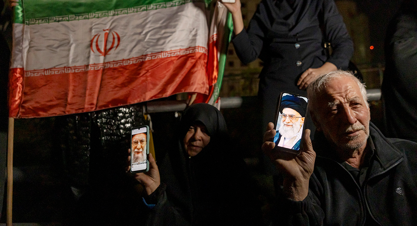 Mourners hold up their phones showing images of Ali Khamenei during a memorial vigil after Iranian state media confirmed the death of Ayatollah Ali Khamenei on March 1, 2026 in Tehran, Iran.