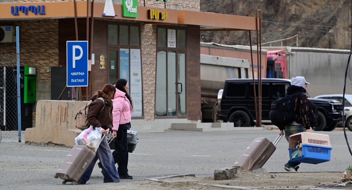 people walking with suitcases
