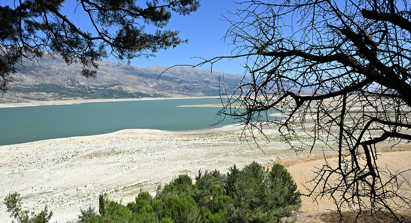 Dried tree branches are seen next to the Qaraoun Lake which has fallen to its lowest water level in history due to last year's insufficient rainfall and this year's increasing heat wave in Beqaa Valley, Lebanon on August 03, 2025