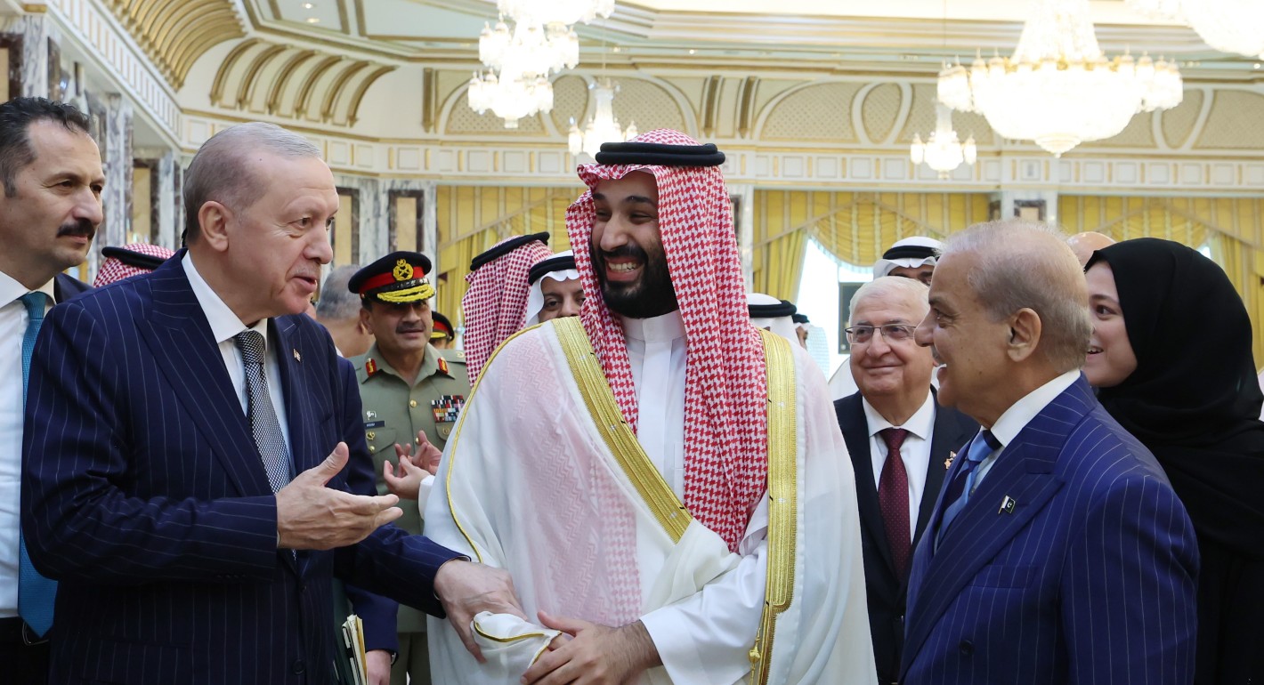 Three men talking and laughing