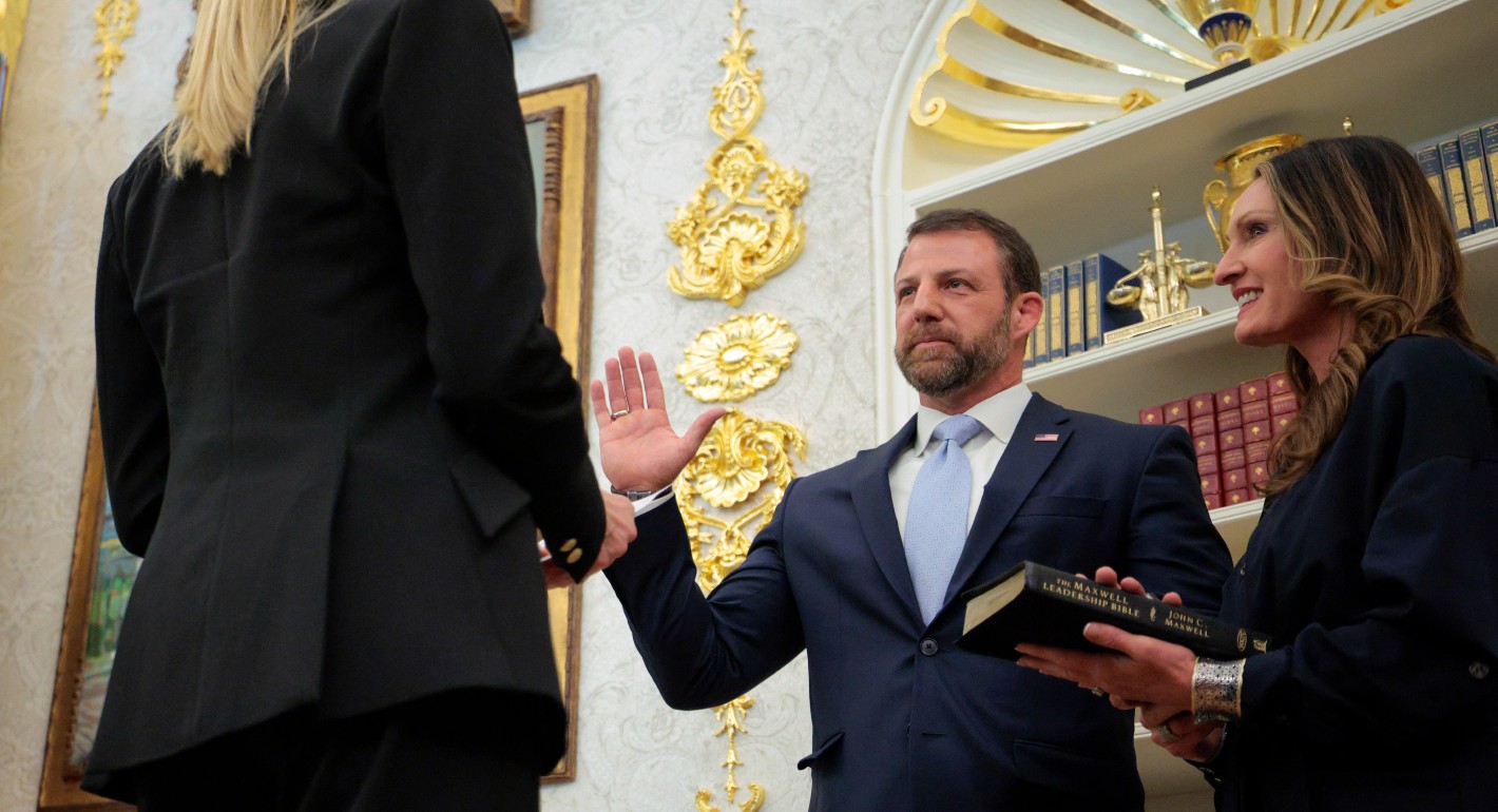 Mullin with his hand raised, taking an oath