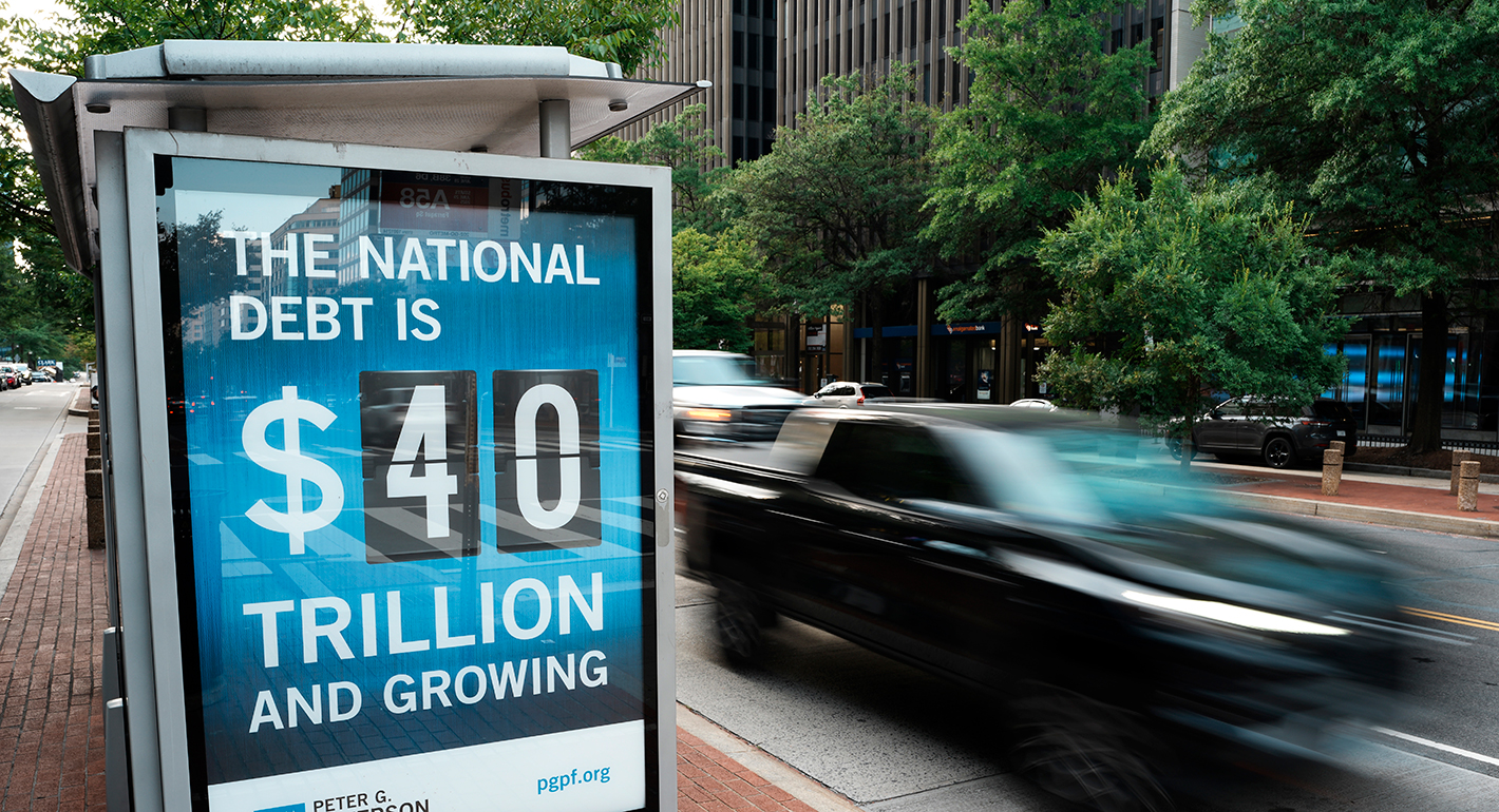 A view of a bus shelter at 18th and K St's NW where a poster and electronic billboard displays the current U.S. National debt per person and as a nation at 40 Trillion dollars on August 30, 2026 in Washington, DC. 