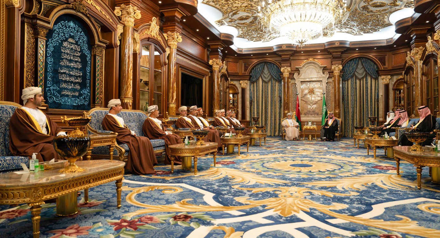 men sitting in an ornate room