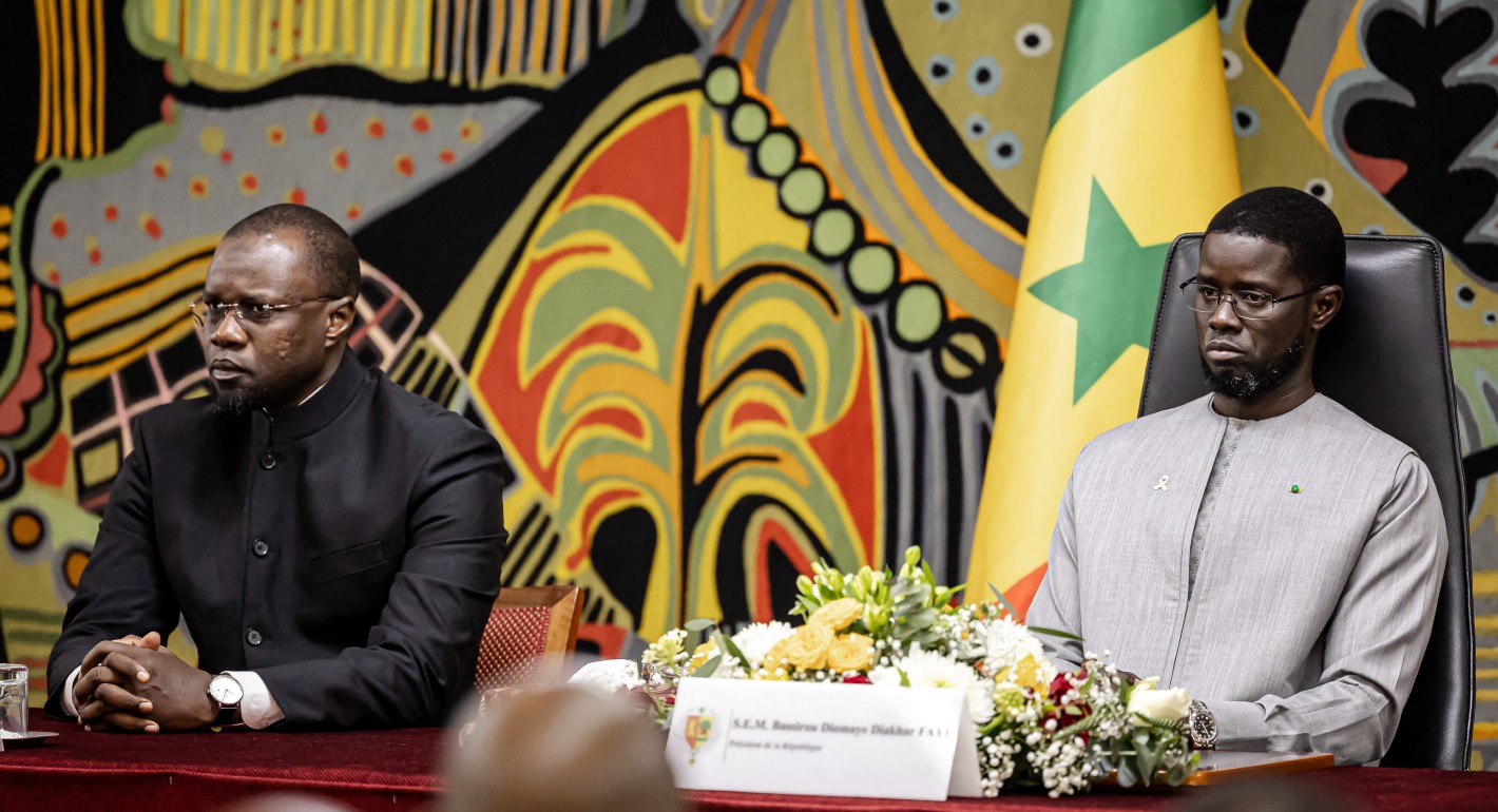 two men sitting next to each other 