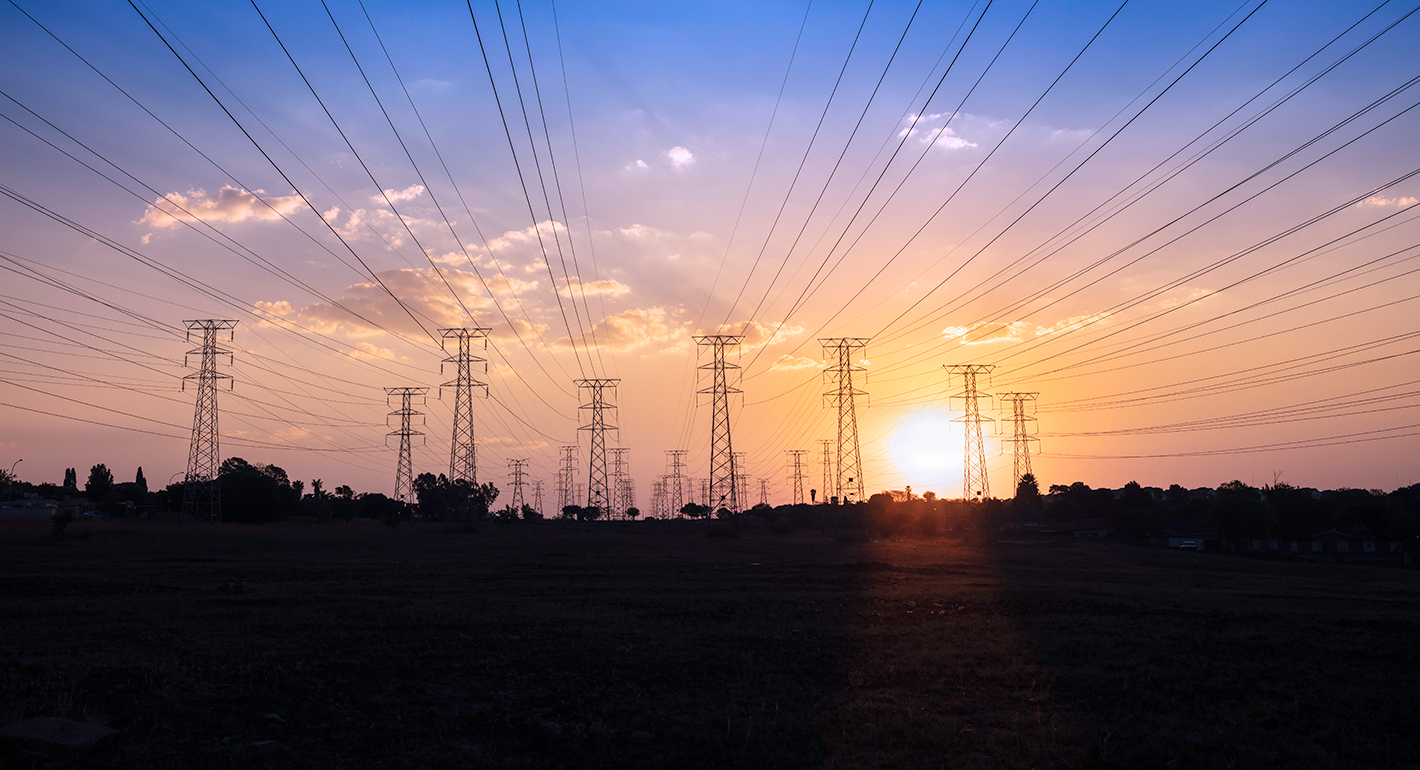 Pylons and power cables sunset silhouette in Johannesburg
