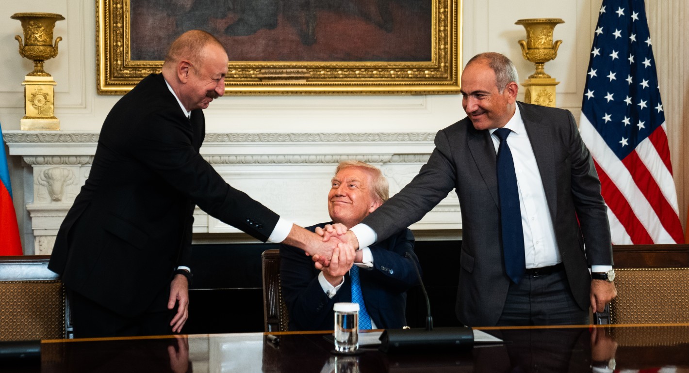 Three men shaking hands at once