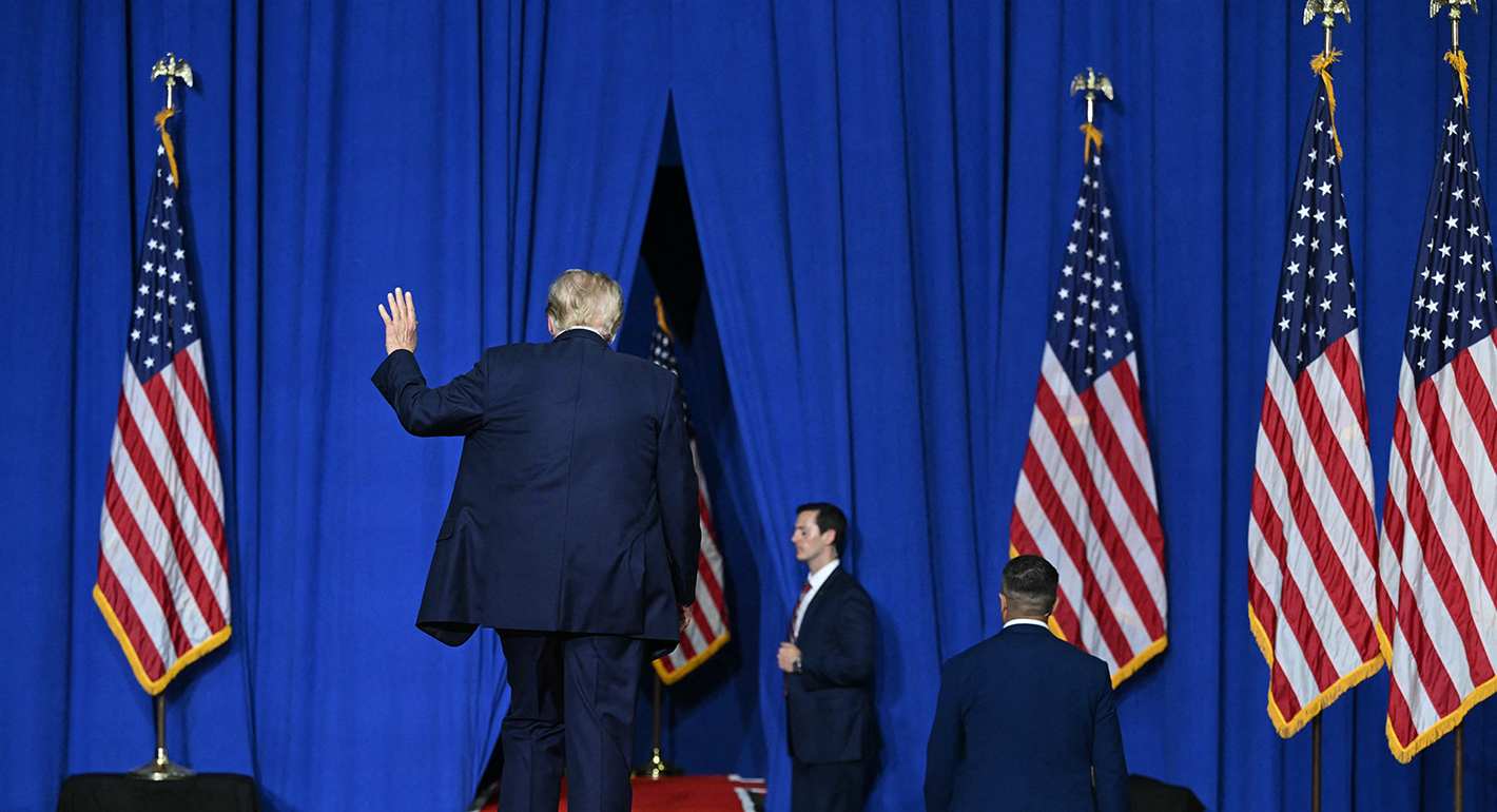 US President Donald Trump waves as he leaves after speaking at a campaign rally 