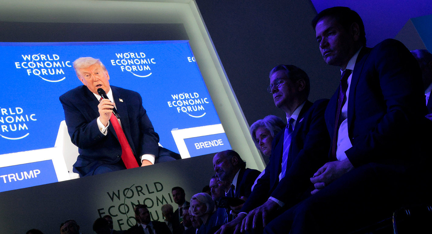 Delegates watch as U.S. President Donald Trump speaks onstage at the World Economic Forum (WEF) on January 21, 2026 in Davos, Switzerland. 