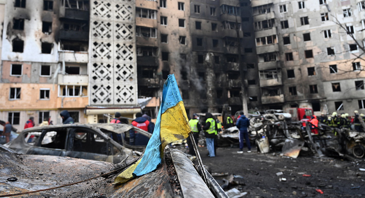 A Ukrainian flag is seen attached to a burned car at the site of a heavily damaged residential building following Russian air strike in the city of Ternopil, on November 19, 2025, amid the Russian invasion of Ukraine. 