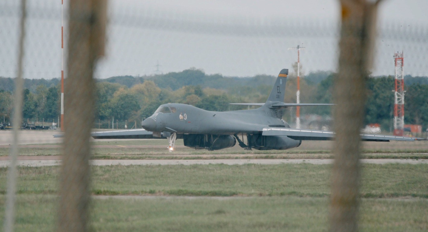 big military plane sitting out in the open 