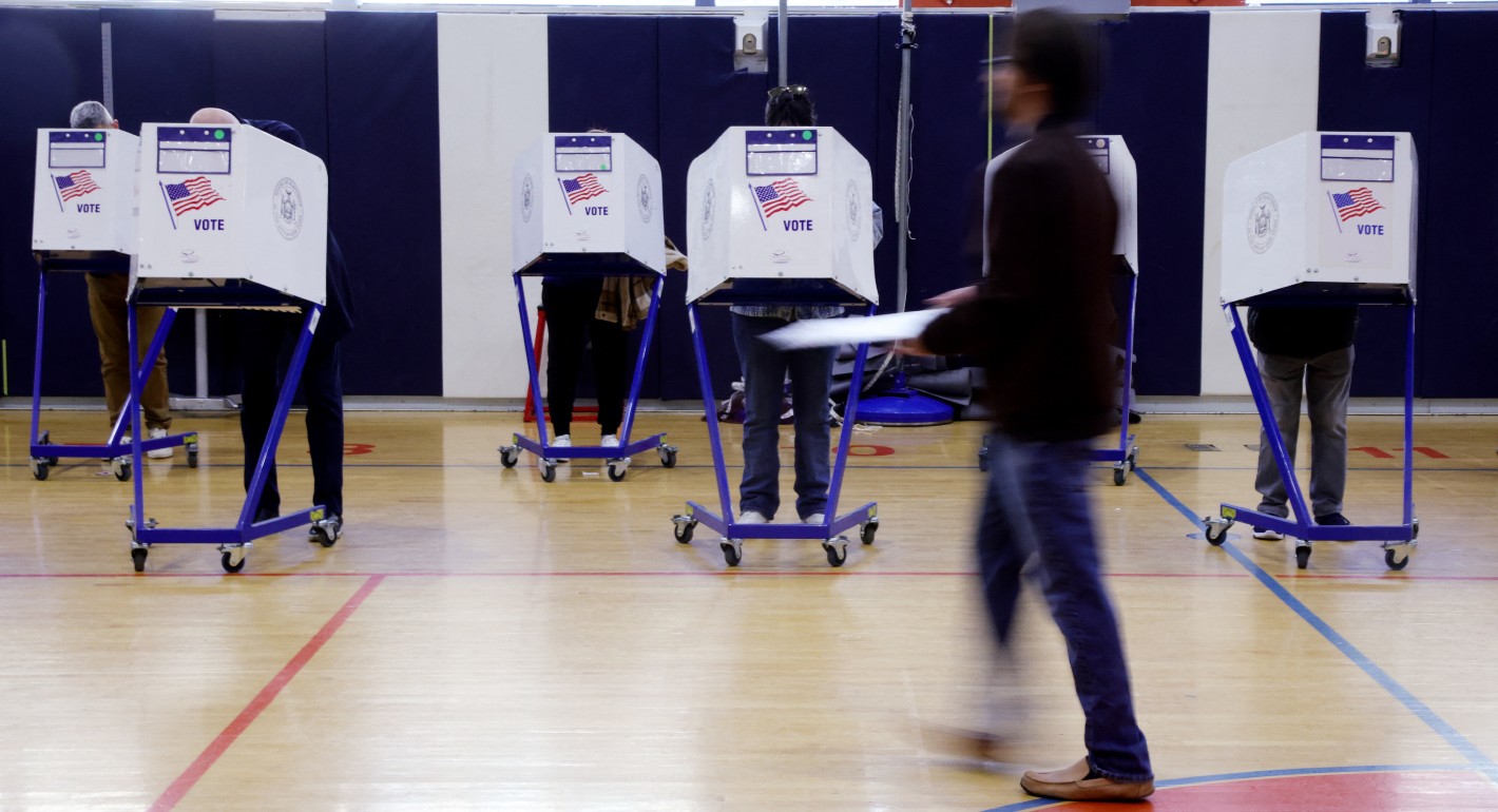 People in voting booths