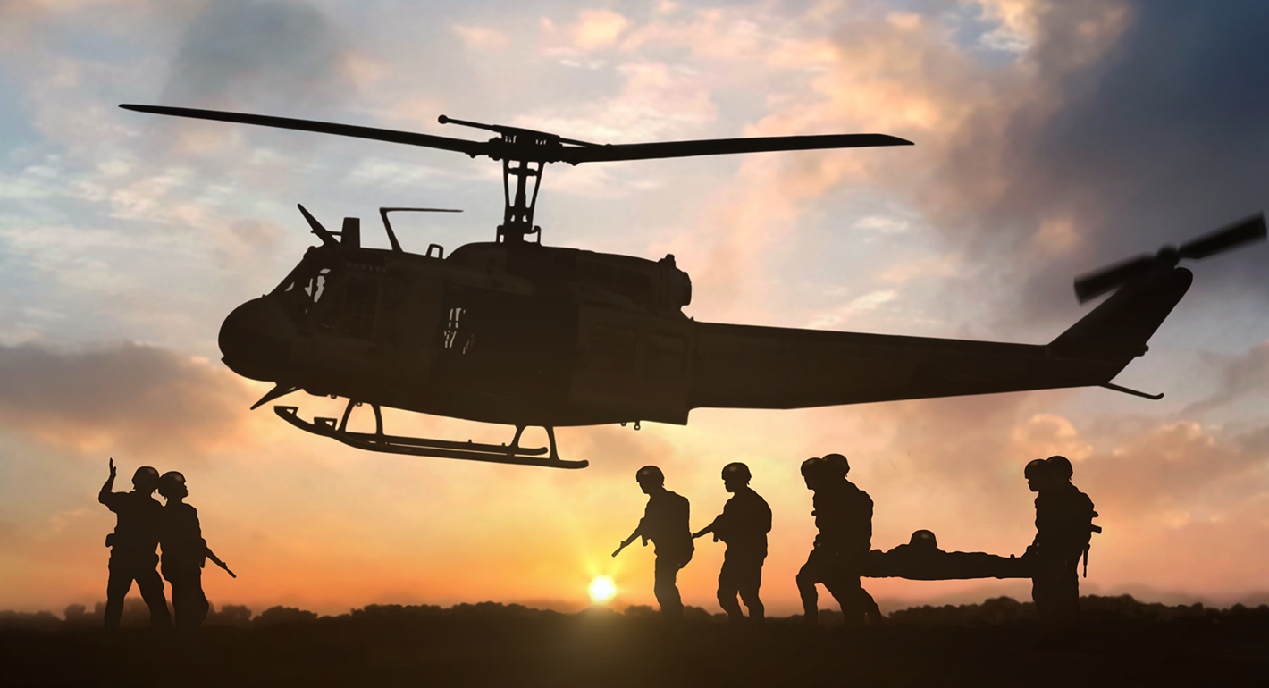 Military rescue helicopter during sunset stock photo