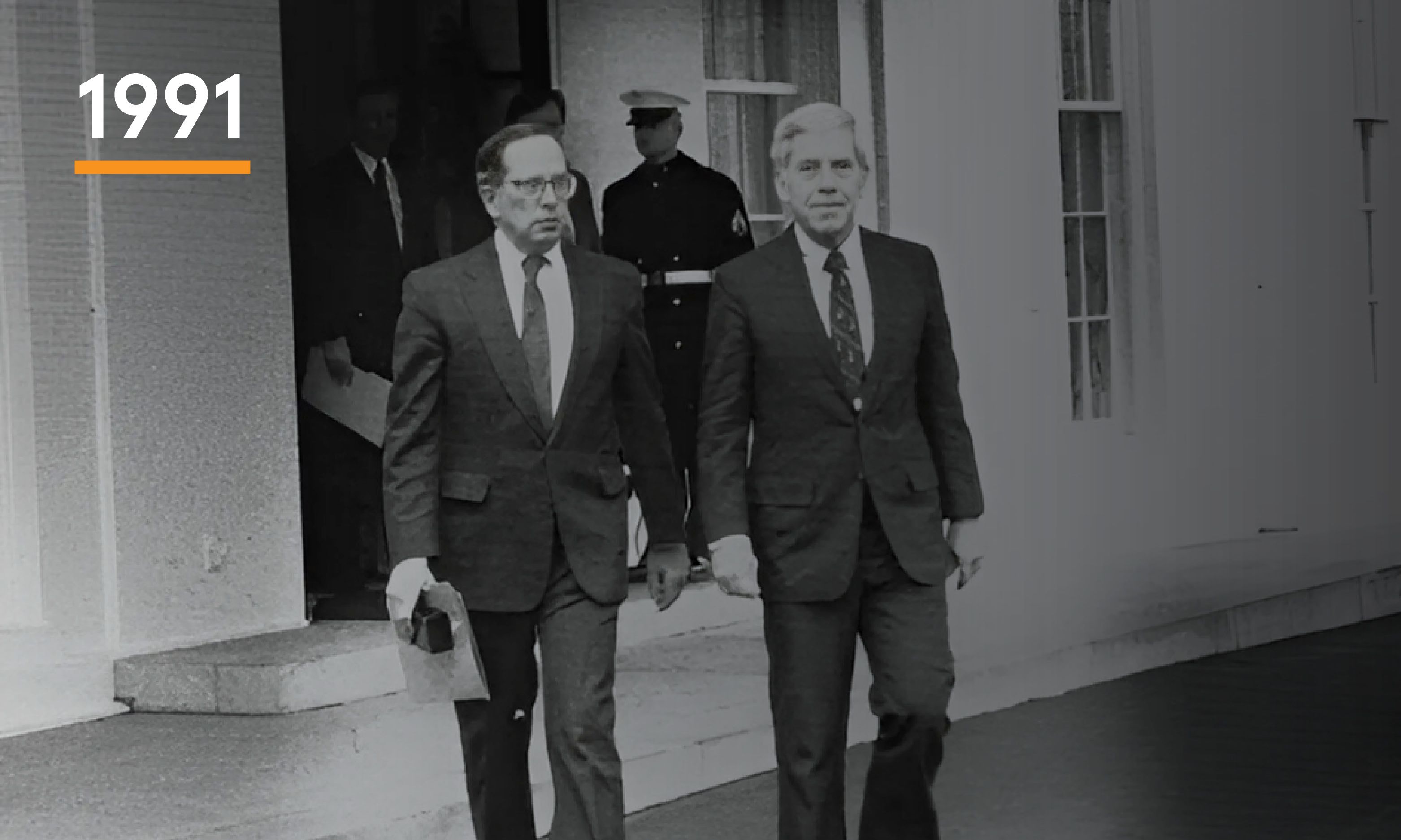 Two men walking away from the White House