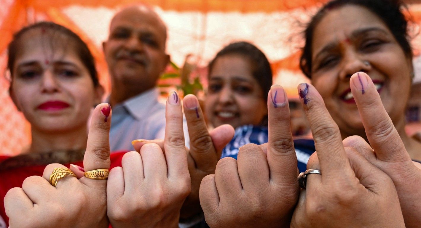 Four Indian voters show their index fingers marked with indelible ink