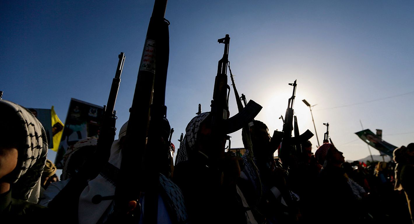 Silhouette of men with guns