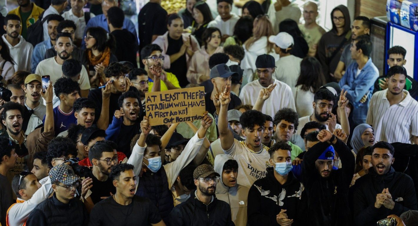 Crowd of young people shouting and raising fists