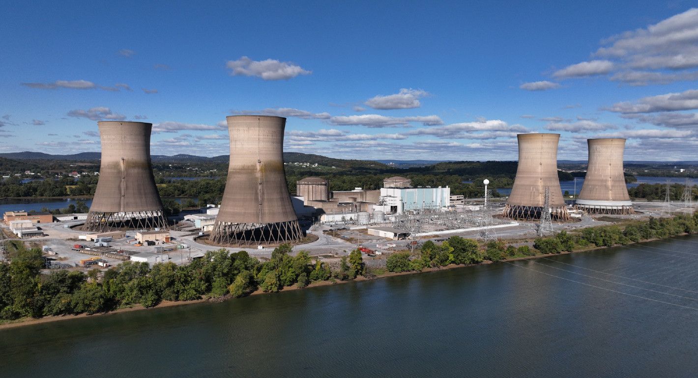 Photo of a disused nuclear power plant next to a river.