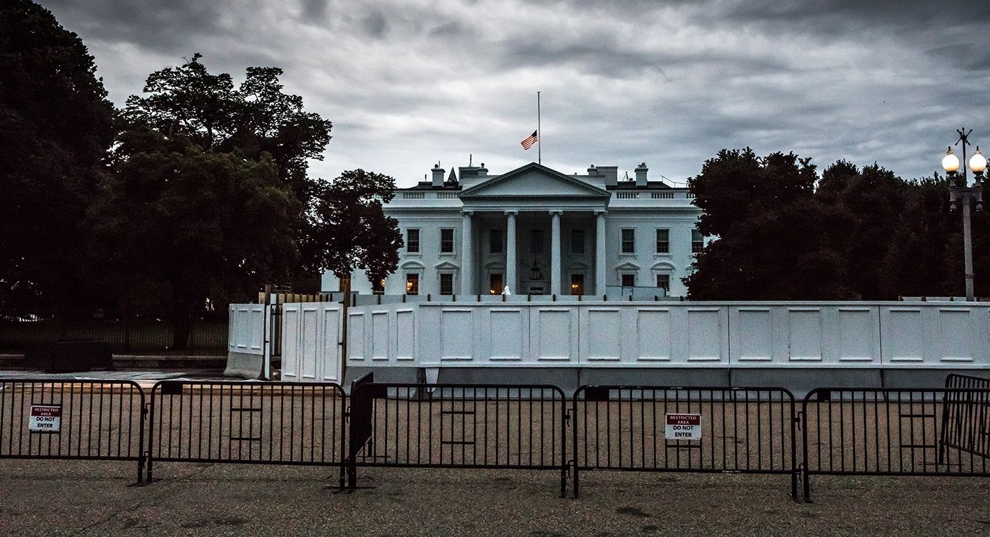 Stormy White House behind multiple fences and barriers