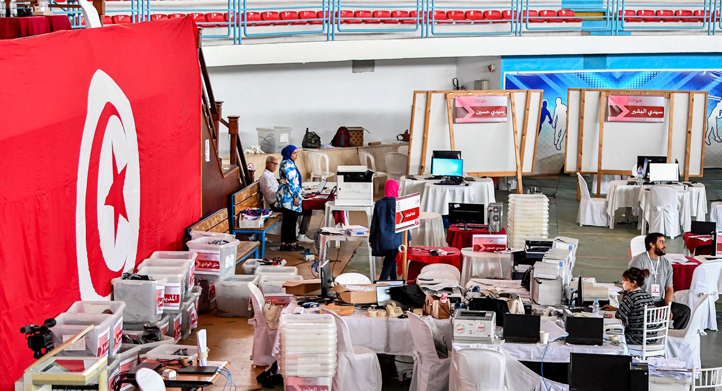 Officials of Tunisia's High Independent Authority for Elections (ISIE) check the latest updates in the vote count after the 2024 presidential elections, at the national tabulation centre at a repurposed indoor sports centre in Tunis on October 7, 2024. 