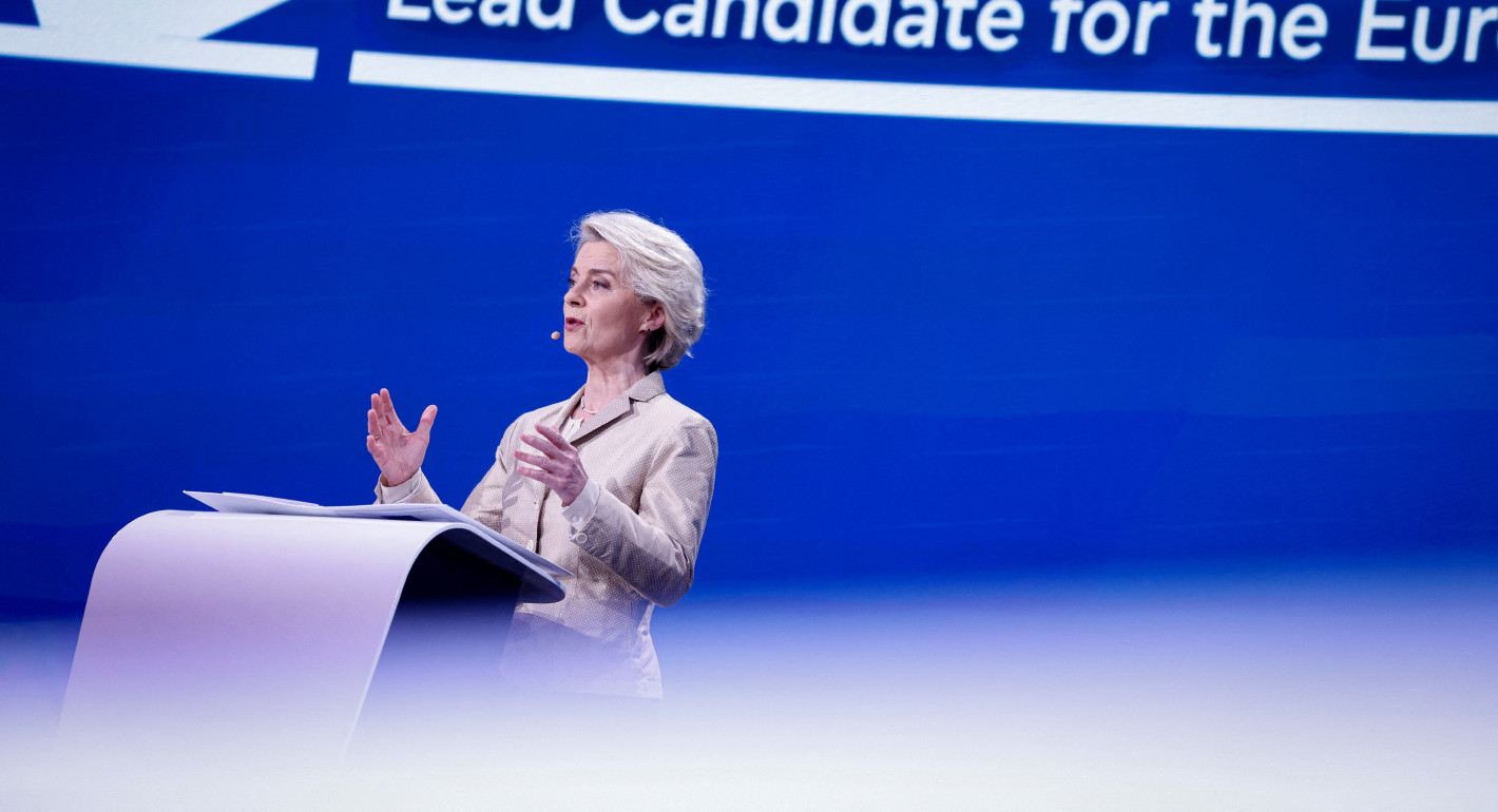 Ursula von der Leyen speaking behind a dais