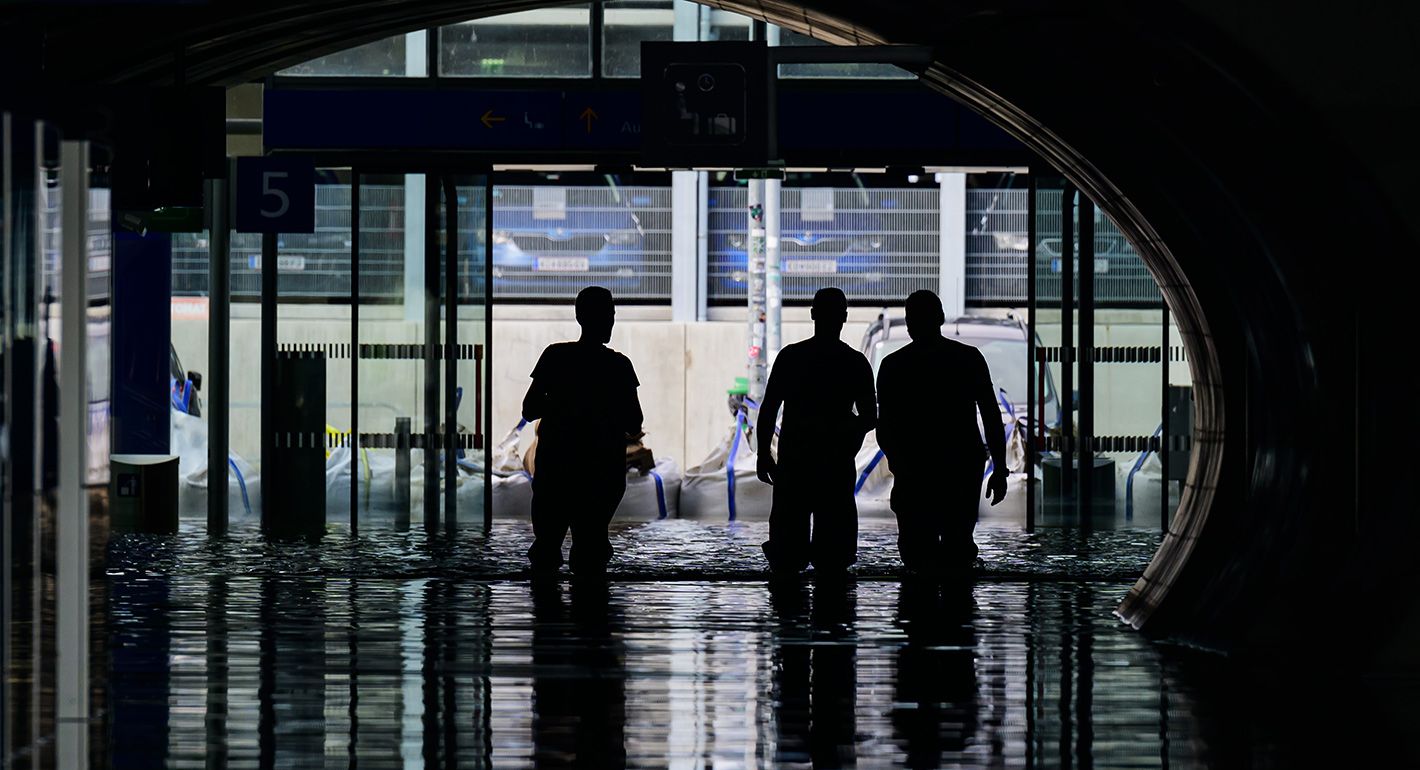 Workers walk in the flooded train station Tullnerfeld after heavy rain on September 17, 2024 in Pixendorf, Austria. 