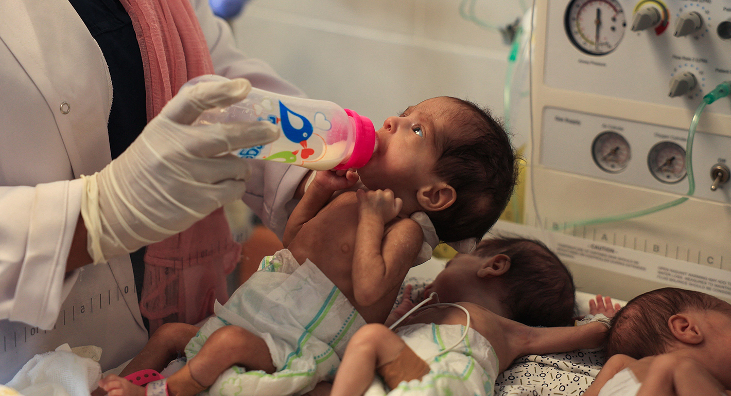 A Palestinian medic cares for premature babies, evacuated from Gaza City's Al Shifa hospital, ahead of their transfer from a hospital in Rafah in the southern Gaza Strip to Egypt, on November 20, 2023, amid ongoing battles between Israel and the militant group Hamas. 