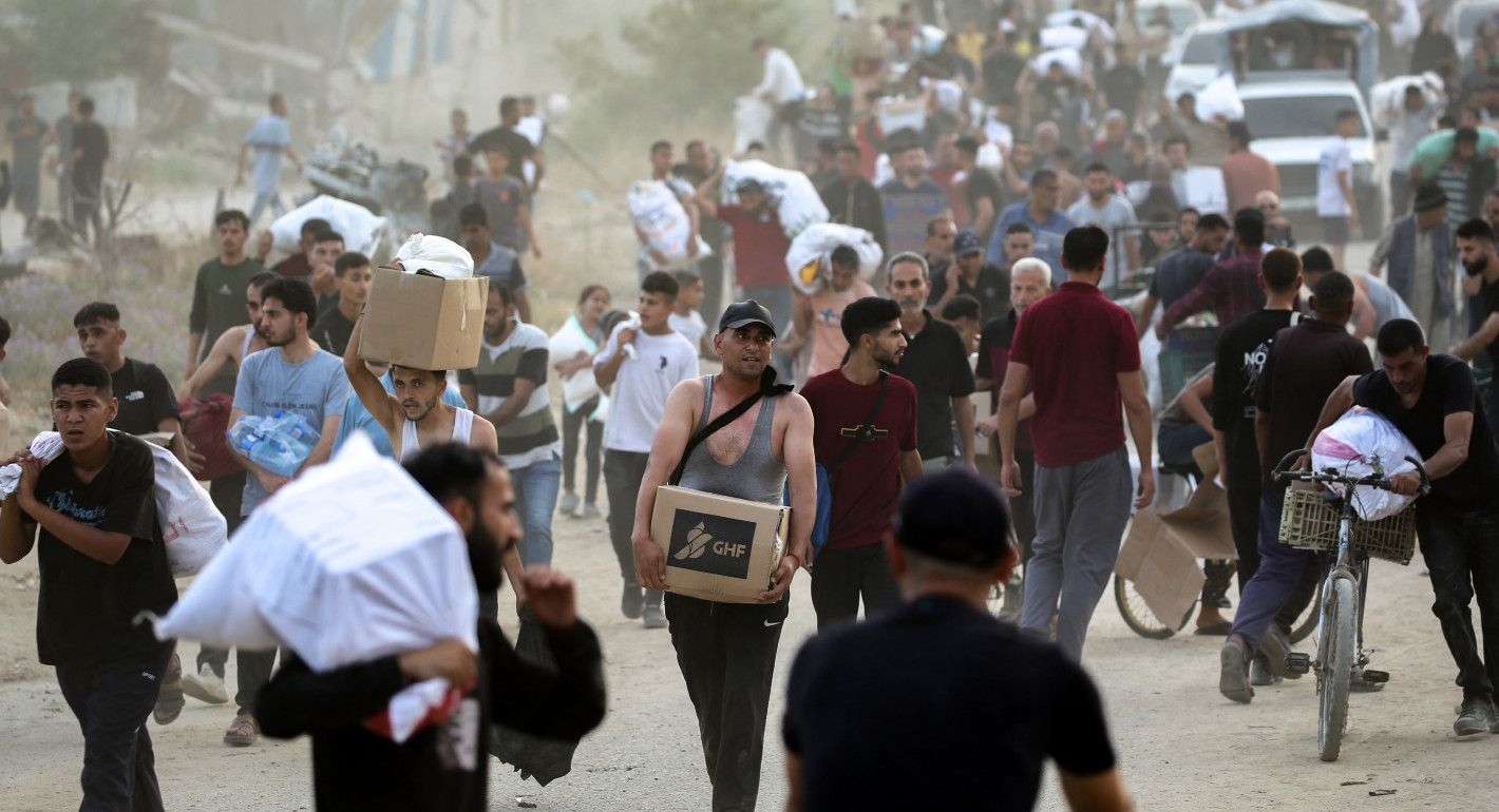 people walking carrying bags and boxes