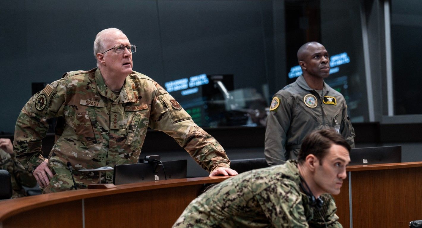 Military personnel watching a screen