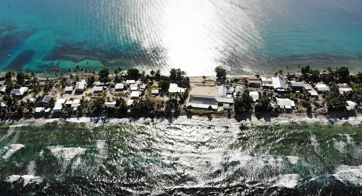 An aerial view of a strip of land between the Pacific Ocean (BOTTOM) and lagoon on November 27, 2019 in Funafuti, Tuvalu. 
