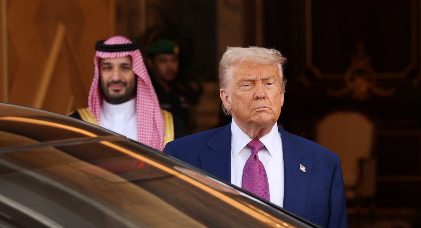Trump getting into a car, with MBS in the background