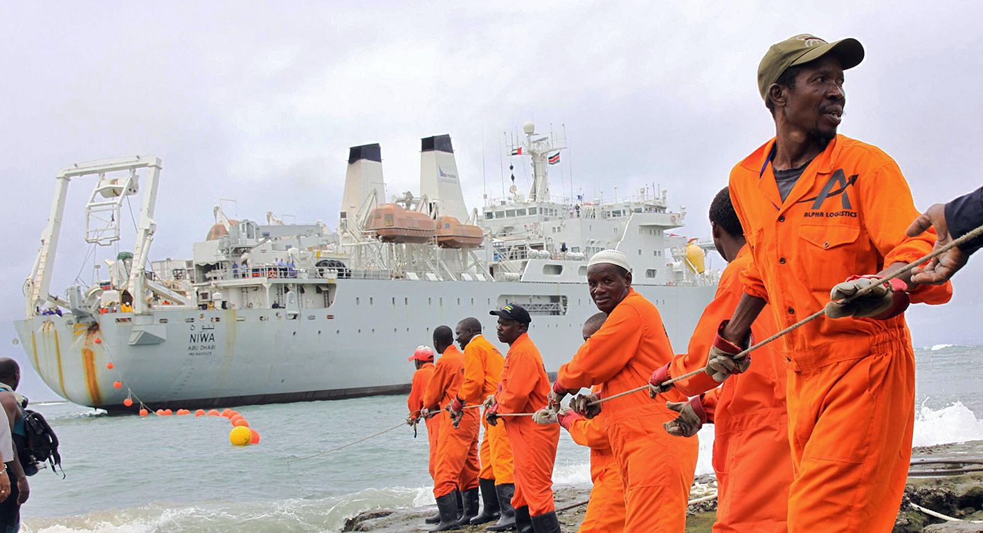 Workers haul part of a fibre optic cable onto the shore at the Kenyan port town of Mombasa on June 12, 2009