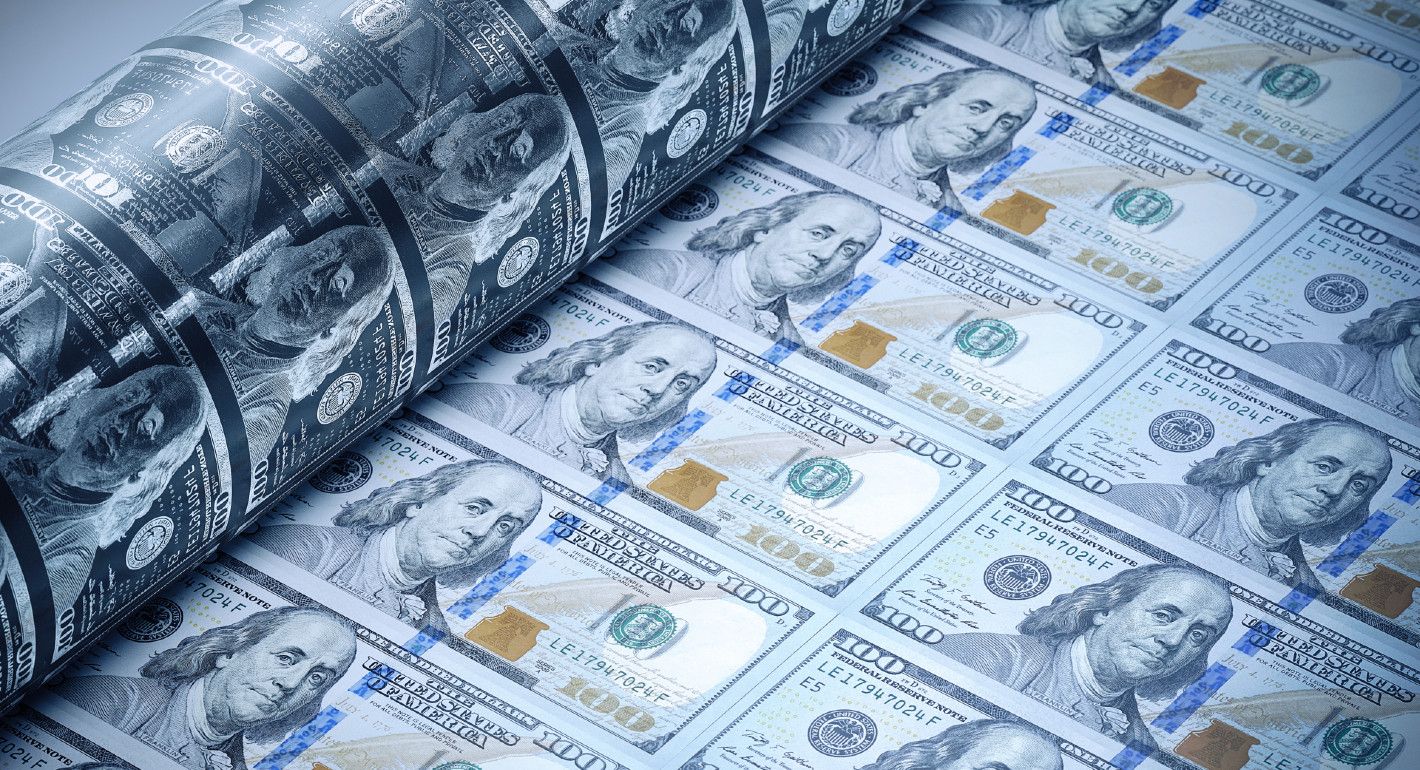 Photo of a sheet of U.S. $100 bills being printed.